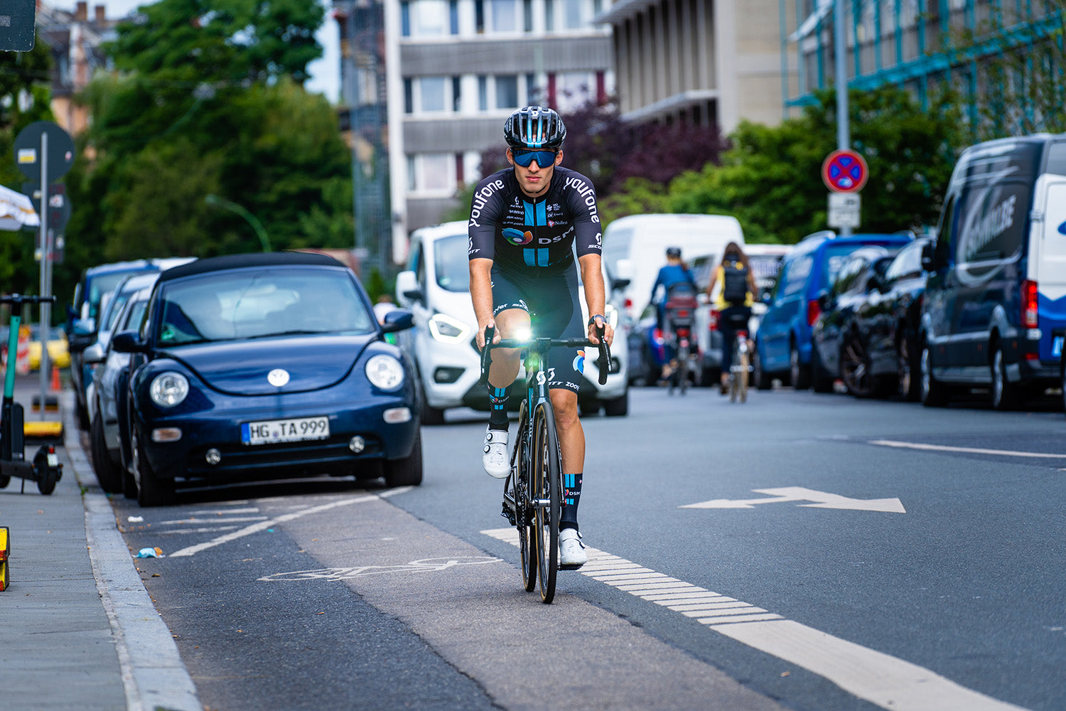 DSM Athlete Riding Bike In City Streets In Uniform