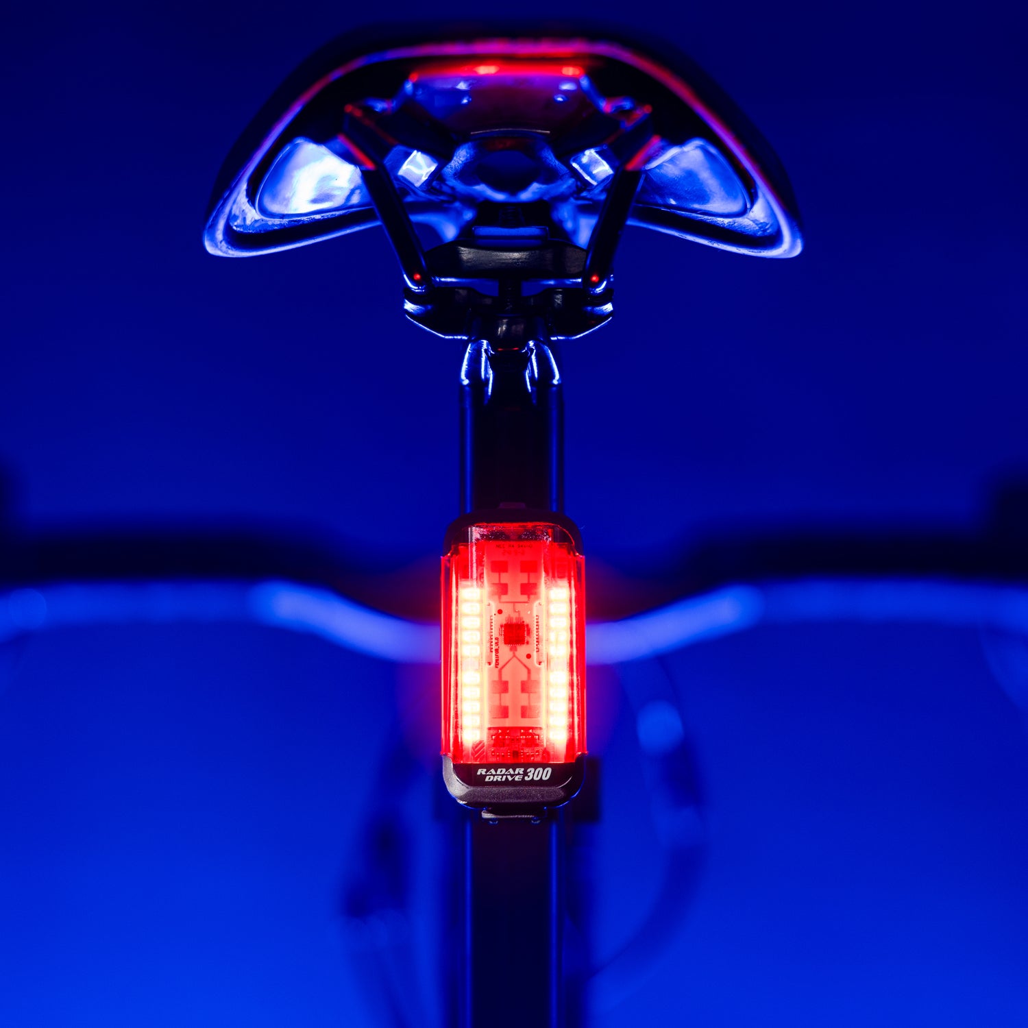 Lezyne Radar Drive LED rear bike light on road bike seatpost; lamp shining to rear, clear beam and reflective details visible.
