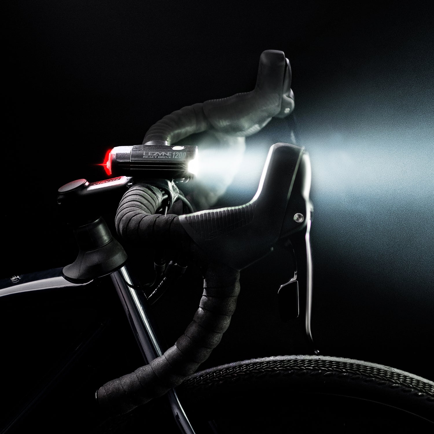 Lezyne React Drive LED front bike light on road bike side view; mounted on sleek handlebar.