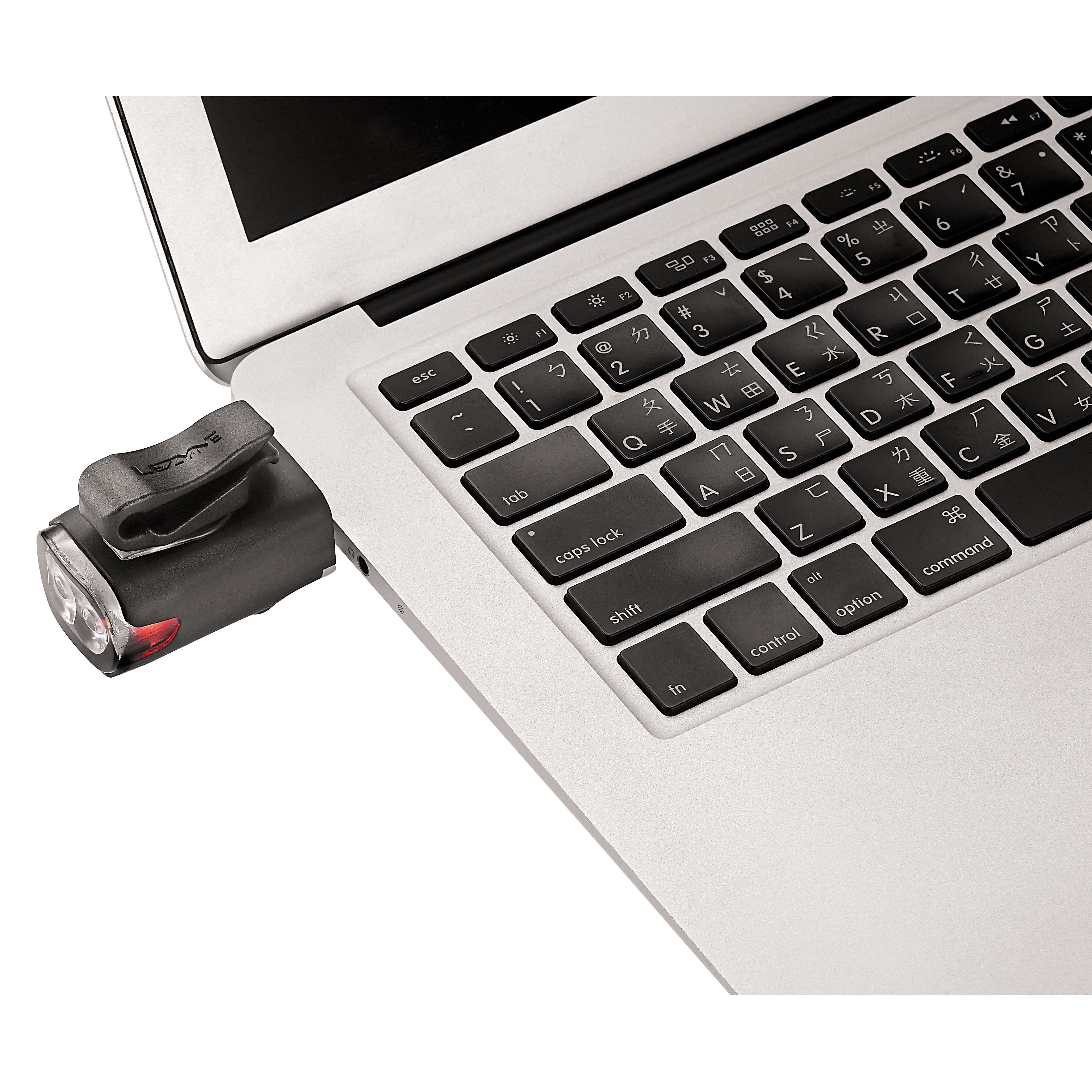 Black KTV Drive front bike light charging using a laptop