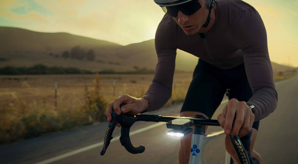 Header image of Lance Haidet cropped tightly in an aero position riding down an open road with the Road Drive 500 shining bright and a golden sunset in the background