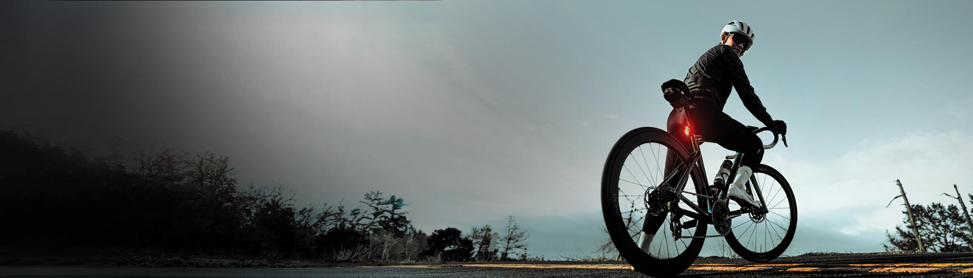 Close-up of two small, bright bike lights on a reflective surface, highlighting their powerful LED glow and sleek design.