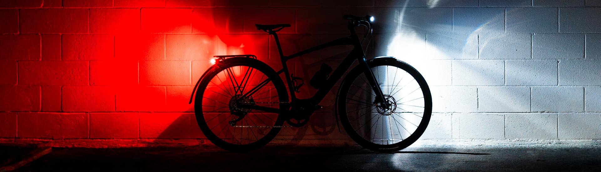 2 small bright bicycle lights on a reflective surface.