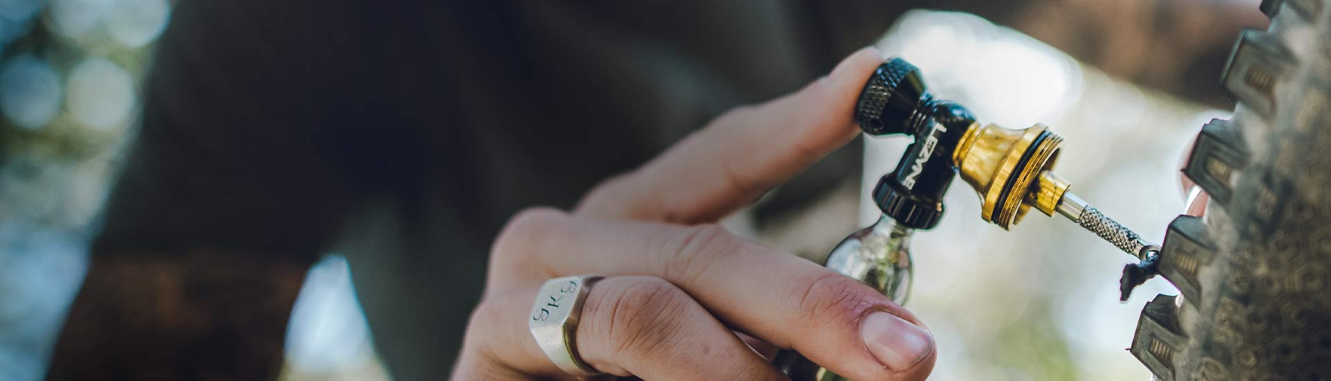 A hand holding a tool with the words Lezyne Pocket Torque Drive printed on the side.