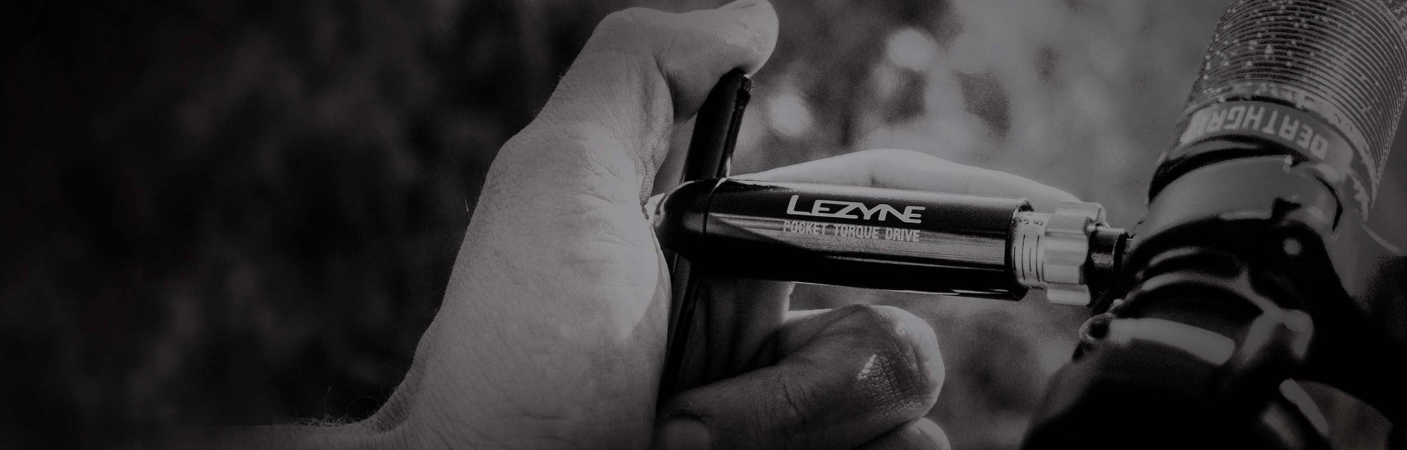 A hand holding a tool with the words Lezyne Pocket Torque Drive printed on the side.