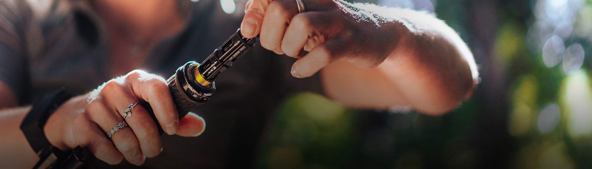 A close up of a tool being inserted in to bicycle handle bars.