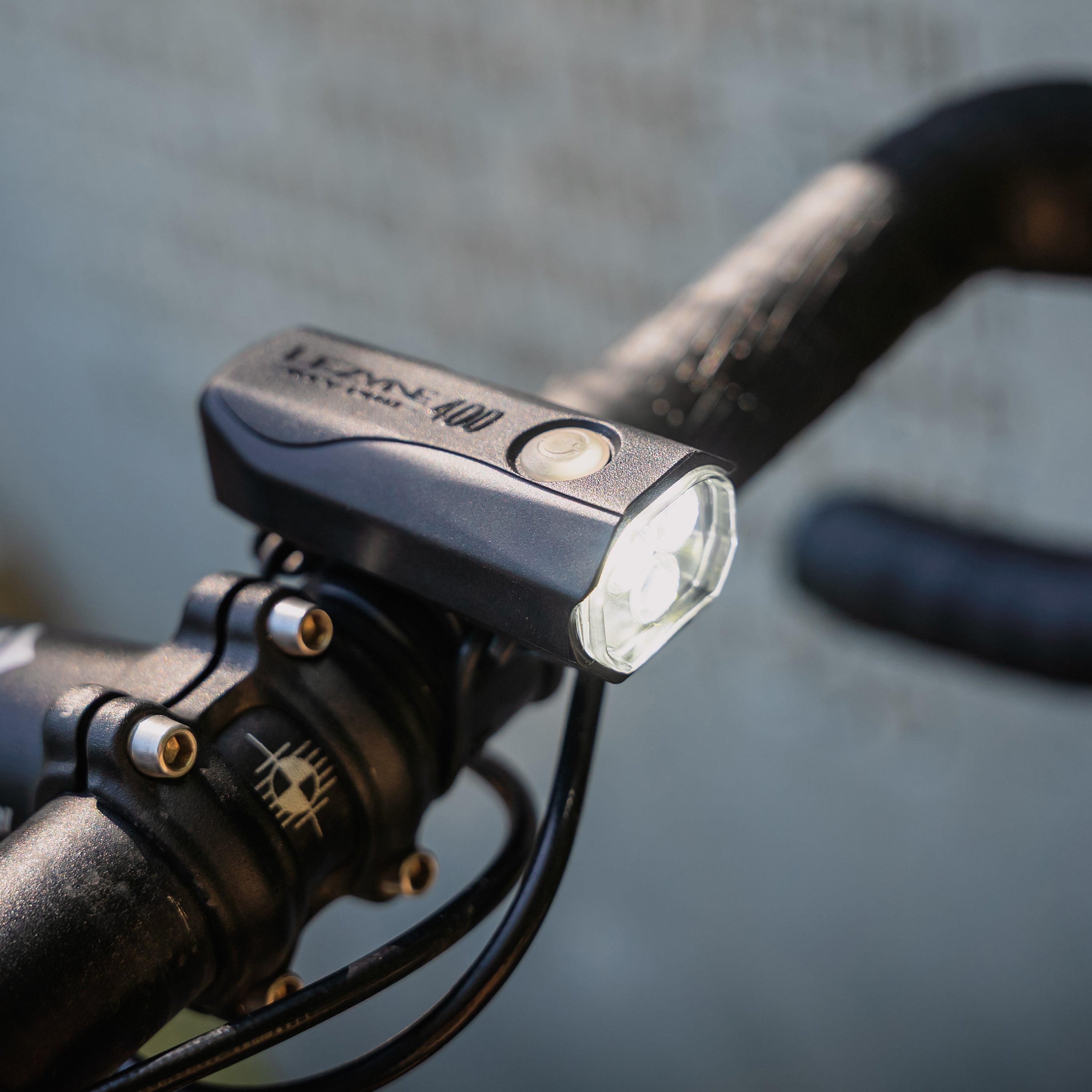 Lezyne KTV Drive Pro 400+ Front bike light mounted on a bike and emitting light in daylight