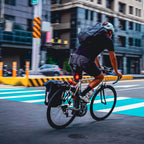 A cyclist commuting through a busy city street, with the bright Lezyne Radar Pro 300 radar taillight providing high visibility among urban traffic.