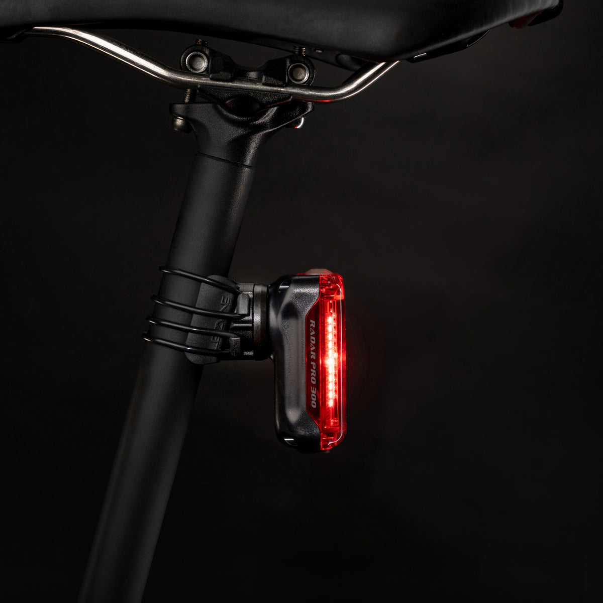 Studio product photography of the Radar Pro 300 cycling radar mounted on a seatpost, viewed from a side angle to show its low-profile fit.