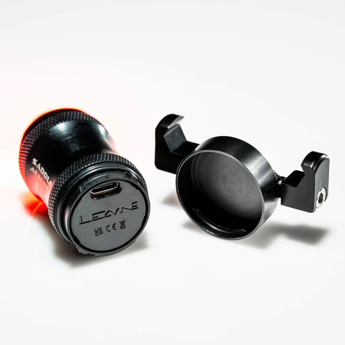 The back side of a bicycle light showing how the back cap can be removed to expose a USB-C port.