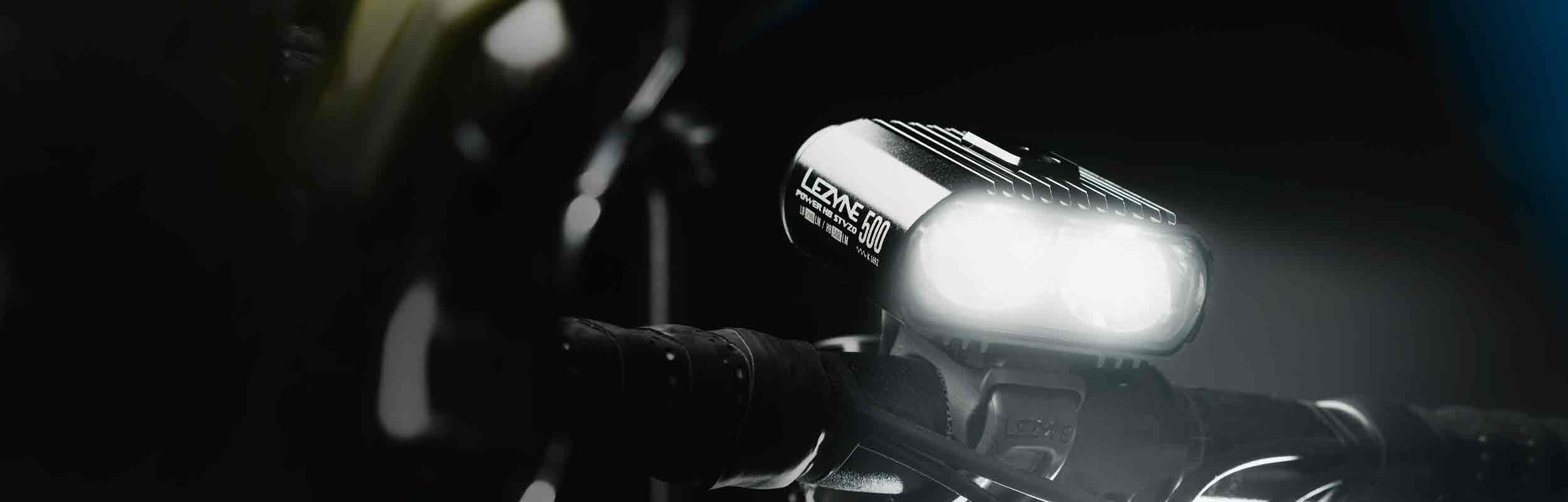 A close up of a bicycle light mounted on handlebars with the words Lezyne Power Pro 500 printed on the side of the light.