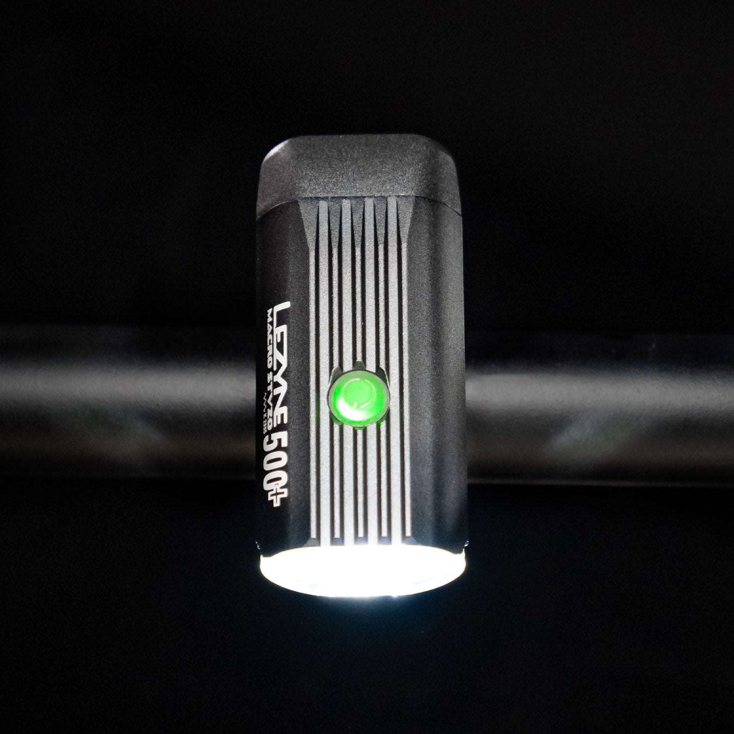 Bird's-eye view of the Lezyne Macro StVZO 500+ front light with a green circular power light on top, mounted on the handlebars.