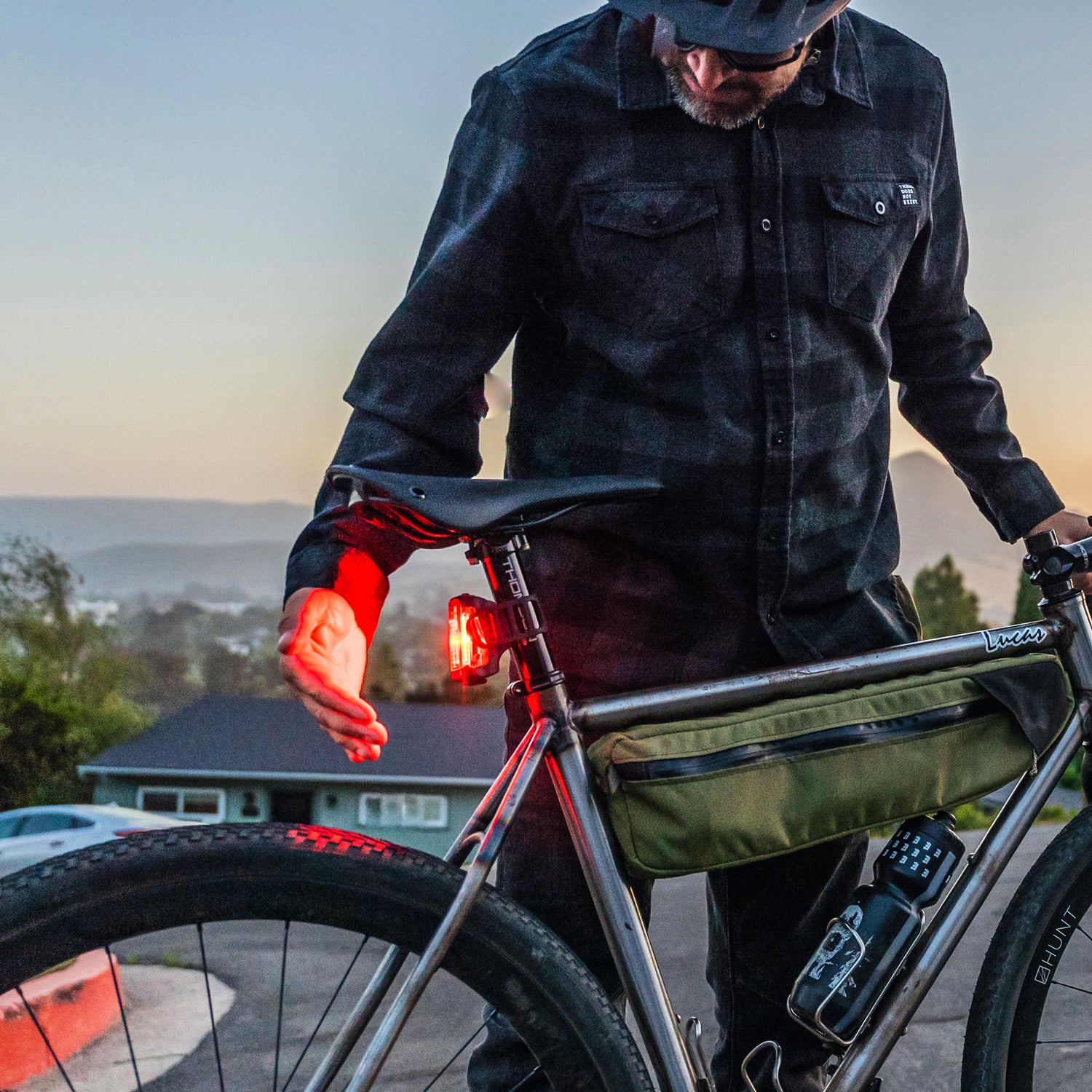 Commuter next to his bike with Lezyne Radar StVZO Rear mounted, receiving radar vehicle alerts from approaching traffic.