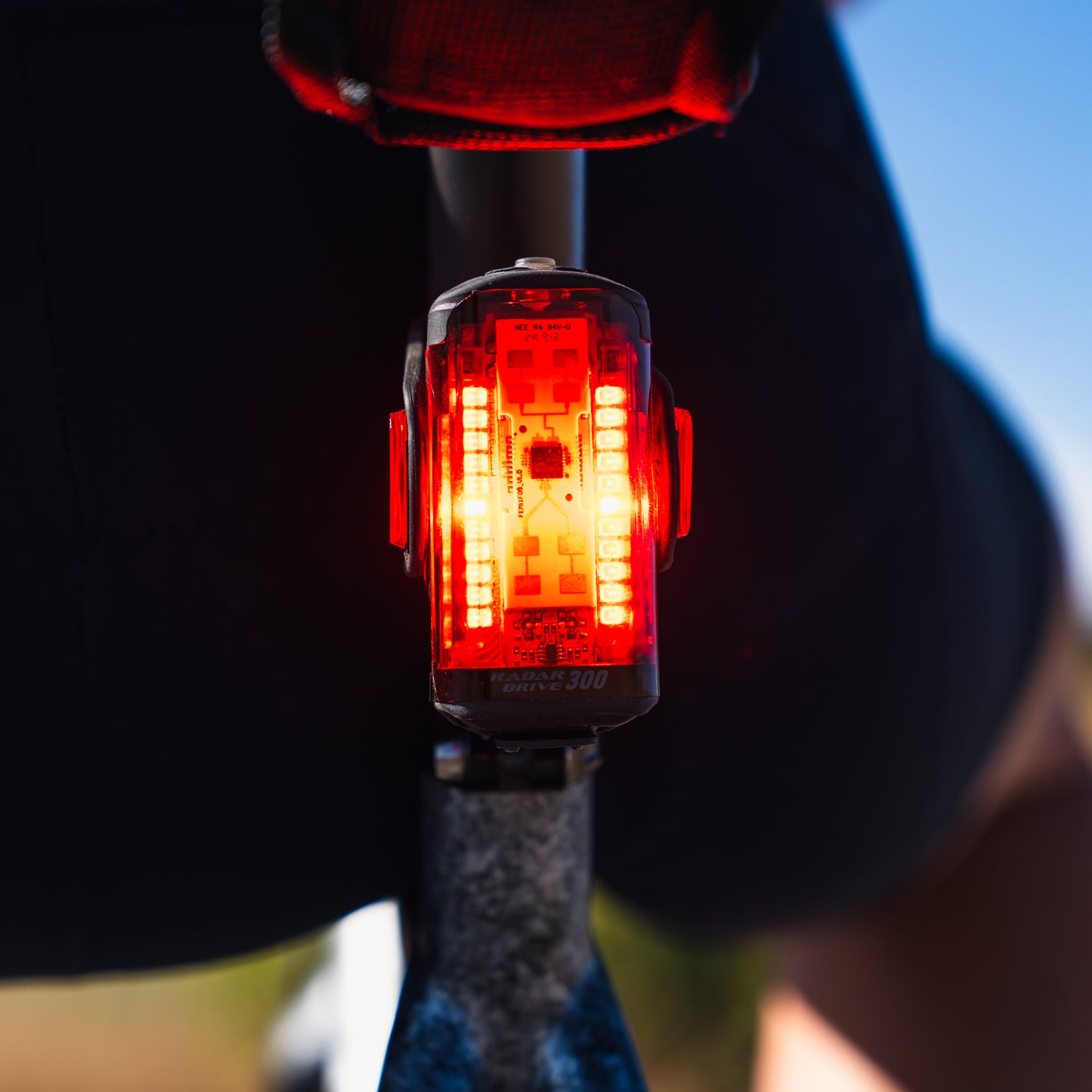 Lezyne Radar Drive LED rear bike light on road bike seatpost; daylight lifestyle image showing discreet fit and secure strap mount.