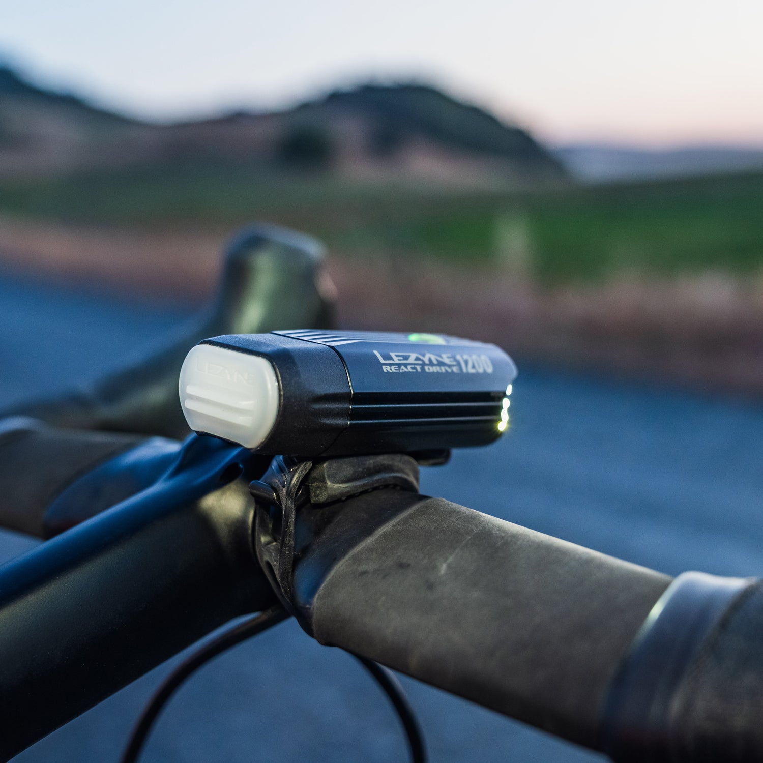 Lezyne React Drive LED front bike light on gravel bike handlebar; side view.