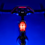 Lezyne Radar Drive LED rear bike light on road bike seatpost; lamp shining to rear, clear beam and reflective details visible.
