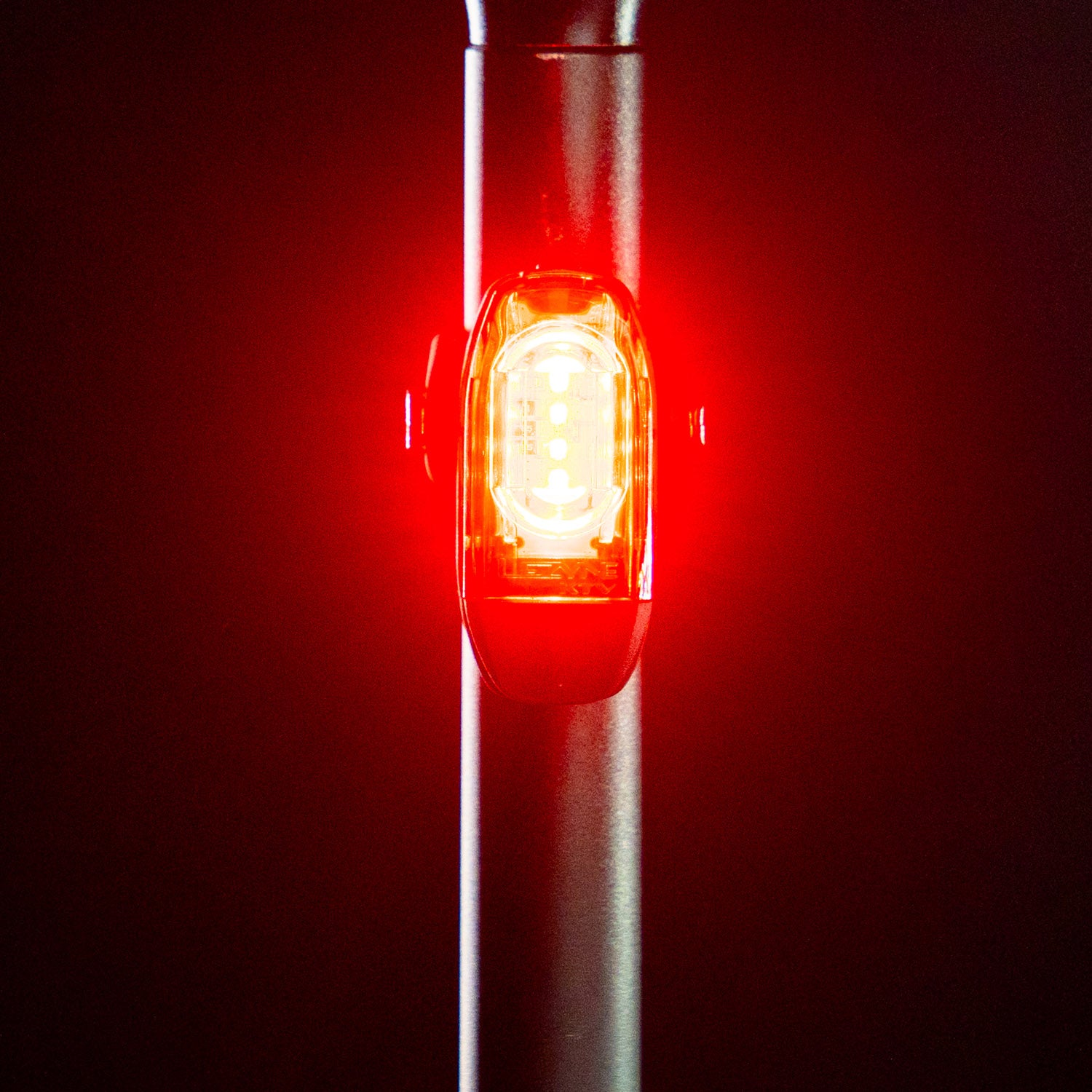 Front view of the Lezyne KTV Drive StVZO Rear LED light, emitting a bright red light, mounted on the seatpost.