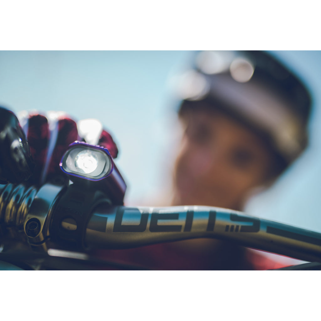 Purple Hecto Drive 500XL front bike light on a mountain bike